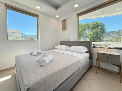 a bedroom with a bed with towels on it at Beachfront 3bedroom apartment in Porto Rafti