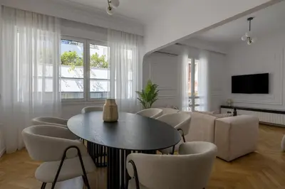a living room with a table and chairs and a couch at Plaka Elegance Retreat in Athens