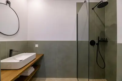a bathroom with a glass shower and a sink at Plaka Elegance Retreat in Athens