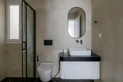 a bathroom with a toilet and a sink and a mirror at Plaka Elegance Retreat in Athens