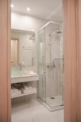 a bathroom with a shower and a sink at Athens Luxury Apartments Lindos in Athens