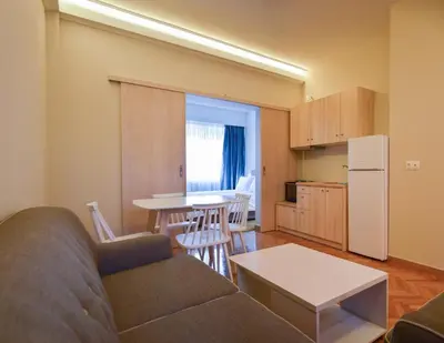 a living room with a couch and a table at Athens Luxury Apartments Lindos in Athens