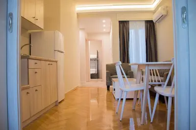 a kitchen and dining room with a table and chairs at Athens Luxury Apartments Lindos in Athens