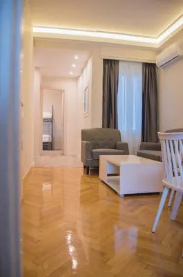 a living room with a couch and a table at Athens Luxury Apartments Lindos in Athens