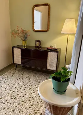 a living room with a table and a mirror at Casa Philoxenia, Acropolis District in Athens