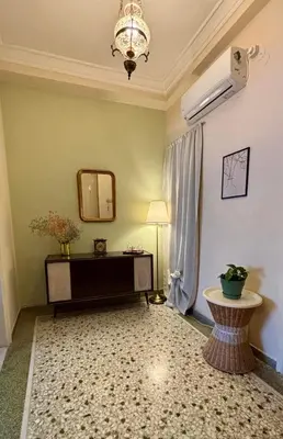 a living room with a table and a mirror at Casa Philoxenia, Acropolis District in Athens