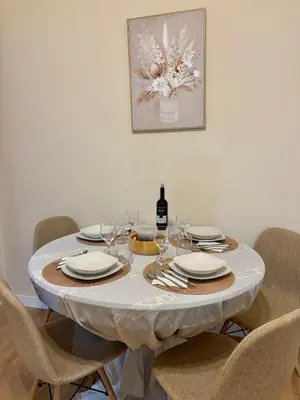 a table with chairs and a bottle of wine at Casa Philoxenia, Acropolis District in Athens