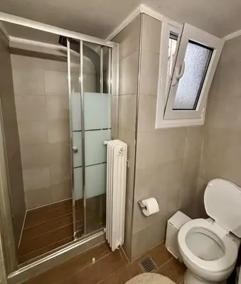 a bathroom with a toilet and a glass shower at Casa Philoxenia, Acropolis District in Athens