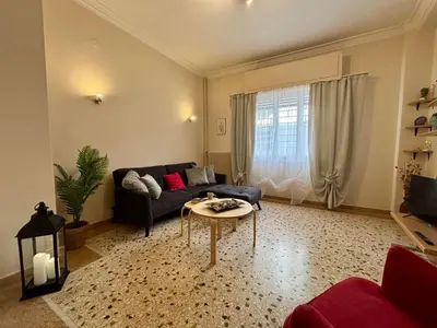 a living room with a couch and a table at Casa Philoxenia, Acropolis District in Athens