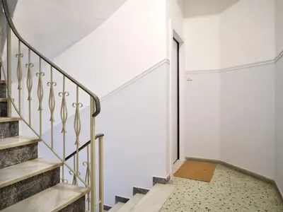 a stairway with white walls and a white stair case at CorNeliApartment in Athens