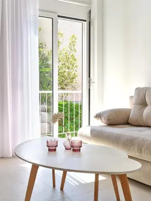 a living room with a white couch and a table at CorNeliApartment in Athens