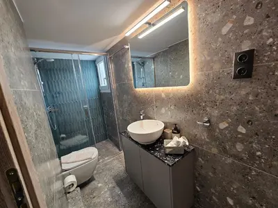 a bathroom with a sink and a toilet and a mirror at Skynest Studio byYHA in Athens