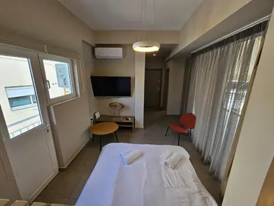 a hotel room with a bed and a tv at Skynest Studio byYHA in Athens