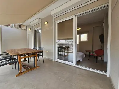 a dining room with a table and a large window at Skynest Studio byYHA in Athens