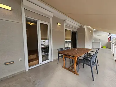 a dining room with a wooden table and chairs at Skynest Studio byYHA in Athens