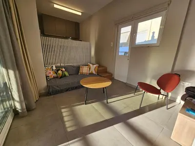 a living room with a couch and two chairs at Skynest Studio byYHA in Athens