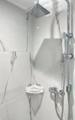 two pictures of a shower in a bathroom at Glyfada Seabreeze Loft B in Athens