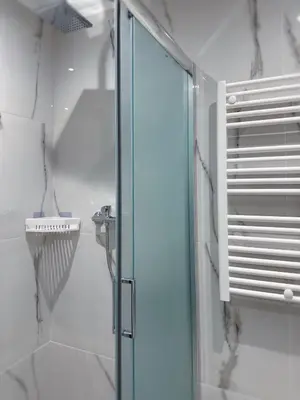 a shower with a glass door in a bathroom at Glyfada Seabreeze Loft B in Athens