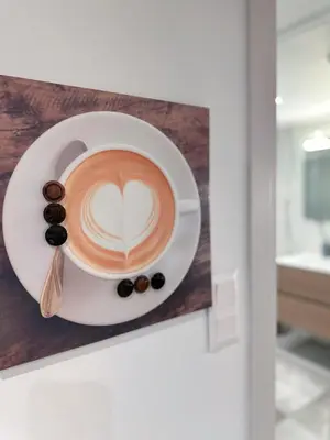 a cup of coffee with a heart painted on it at Glyfada Seabreeze Loft B in Athens