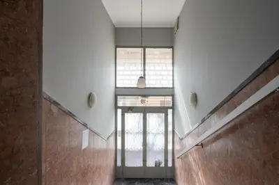 a hallway with a glass door and a window at Aminandrou Boutique Apartments, Walk to Acropolis in Athens
