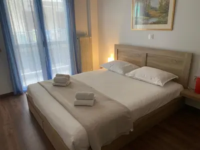 a bedroom with a bed with two towels on it at Cozy & Connected, Walk to Culture, Metro in Minutes in Athens