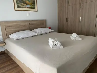 a bedroom with a bed with towels on it at Cozy & Connected, Walk to Culture, Metro in Minutes in Athens