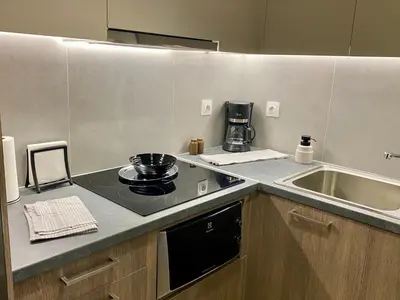 a kitchen with a sink and a stove top oven at Cozy & Connected, Walk to Culture, Metro in Minutes in Athens
