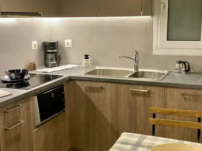 a kitchen with a sink and a counter top at Cozy & Connected, Walk to Culture, Metro in Minutes in Athens