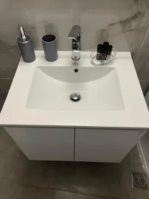 a white sink in a bathroom with bottles on it at Jimilio 2 in Spáta