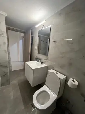 a bathroom with a white toilet and a sink at Jimilio 2 in Spáta