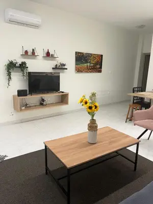 a living room with a vase of flowers on a coffee table at Jimilio 2 in Spáta