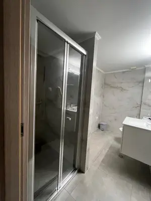 a bathroom with a shower and a sink at Jimilio 2 in Spáta