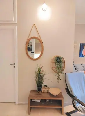 a living room with a mirror and a table at Vouliagmeni Top Floor Maisonette in Athens