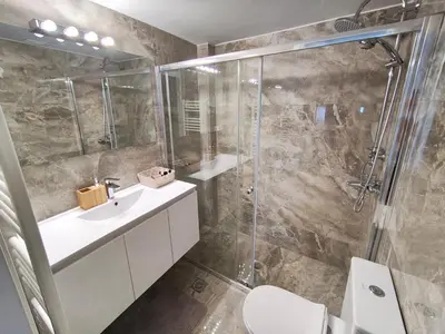 a bathroom with a shower and a sink and a toilet at Voula Hill Panoramic Views of Sea and Athens 129 sqm 2 bedrooms 2 bathrooms Big Fully Equipped New Apartment Peaceful in Athens