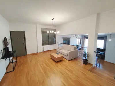 a living room with a couch and a table at Voula Hill Panoramic Views of Sea and Athens 129 sqm 2 bedrooms 2 bathrooms Big Fully Equipped New Apartment Peaceful in Athens
