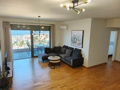 a living room with a couch and a table at Voula Hill Panoramic Views of Sea and Athens 129 sqm 2 bedrooms 2 bathrooms Big Fully Equipped New Apartment Peaceful in Athens