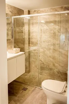 a bathroom with a toilet and a glass shower at Voula Hill Panoramic Views of Sea and Athens 129 sqm 2 bedrooms 2 bathrooms Big Fully Equipped New Apartment Peaceful in Athens