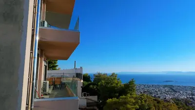 a balcony of a building with a view of the ocean at Voula Hill Panoramic Views of Sea and Athens 129 sqm 2 bedrooms 2 bathrooms Big Fully Equipped New Apartment Peaceful in Athens