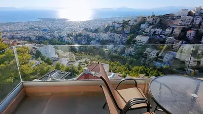 a balcony with a table and chairs and a view at Voula Hill Panoramic Views of Sea and Athens 129 sqm 2 bedrooms 2 bathrooms Big Fully Equipped New Apartment Peaceful in Athens