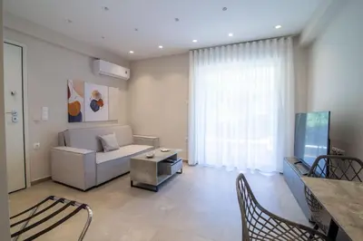 a living room with a couch and a table at Nafsika Cozy Flat A - Glyfada in Athens
