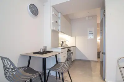 a small kitchen with a table and chairs at Nafsika Cozy Flat A - Glyfada in Athens