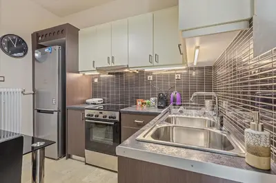a kitchen with a sink and a refrigerator at 3BD Luxury Apartment close to Metro in Athens