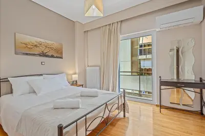 a bedroom with a large bed and a piano at 3BD Luxury Apartment close to Metro in Athens