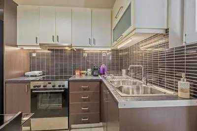 a kitchen with a sink and a stove at 3BD Luxury Apartment close to Metro in Athens