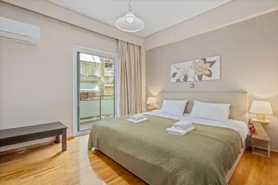 a bedroom with a large bed and a window at 3BD Luxury Apartment close to Metro in Athens