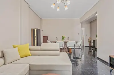 a living room with a white couch and a table at 3BD Luxury Apartment close to Metro in Athens