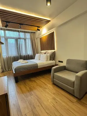 a bedroom with a bed and a couch and a chair at Acropolis View 301 By Pantheon Ermou in Athens