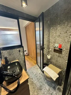 a bathroom with a sink and a glass shower at Acropolis View 301 By Pantheon Ermou in Athens