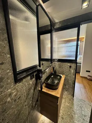 a bathroom with a black sink and some windows at Acropolis View 301 By Pantheon Ermou in Athens