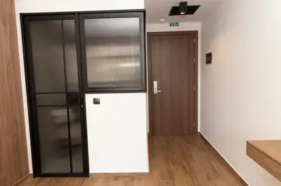 a room with a refrigerator and a door at Acropolis View 301 By Pantheon Ermou in Athens